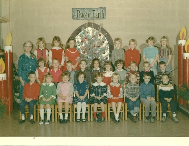 Miss Whitworth's first grade classroom.  I'm in the middle row-- 6th from the left in the red and white dress. 1965